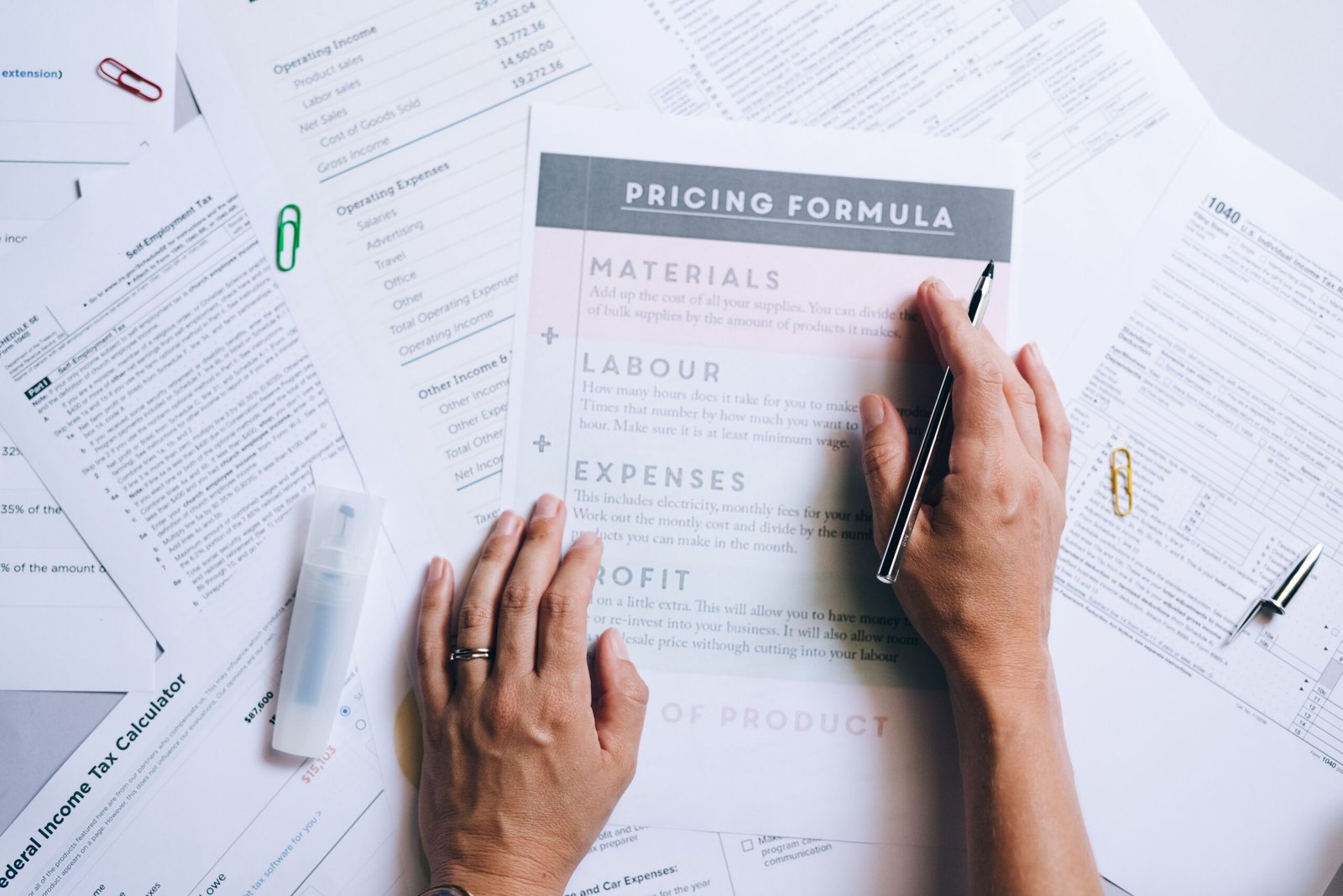 Hands reviewing web design package documents and pricing details