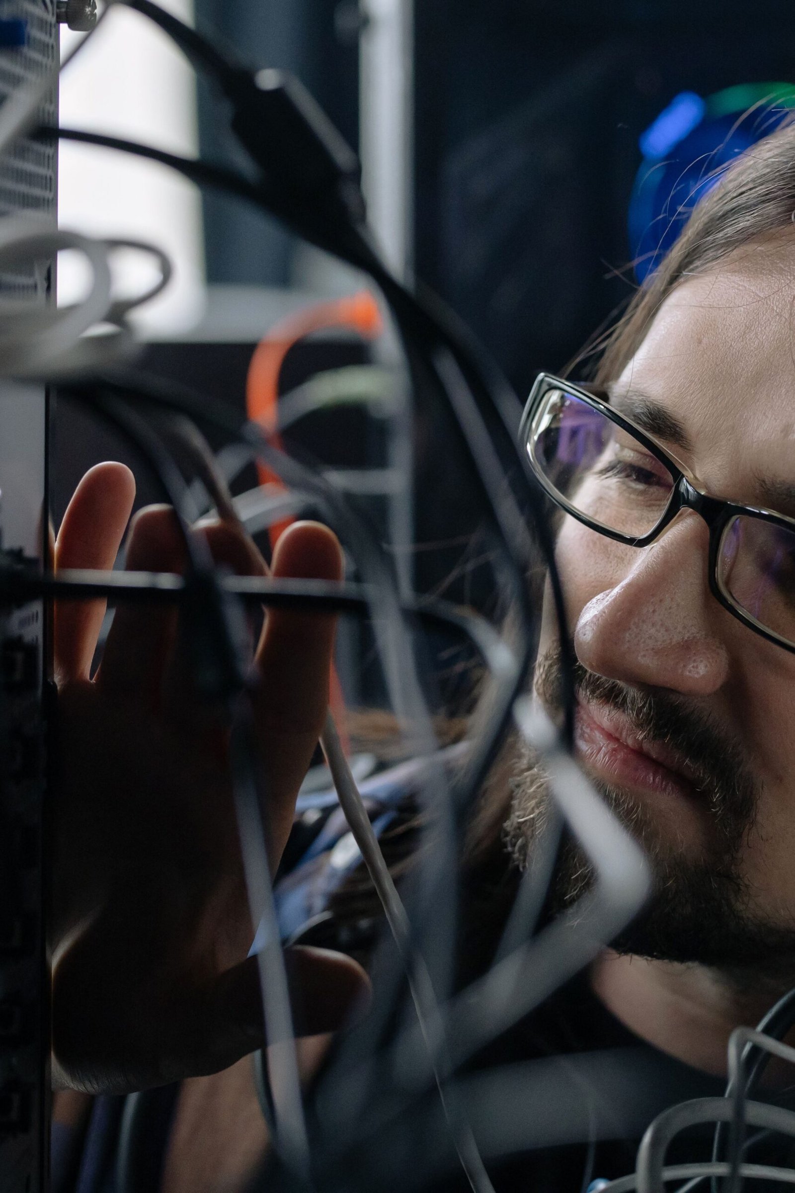 IT specialist managing network cables for secure website hosting and maintenance