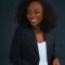 Elegant African woman in a blue blazer smiling