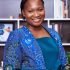 Smiling African businesswoman in a colorful blue outfit